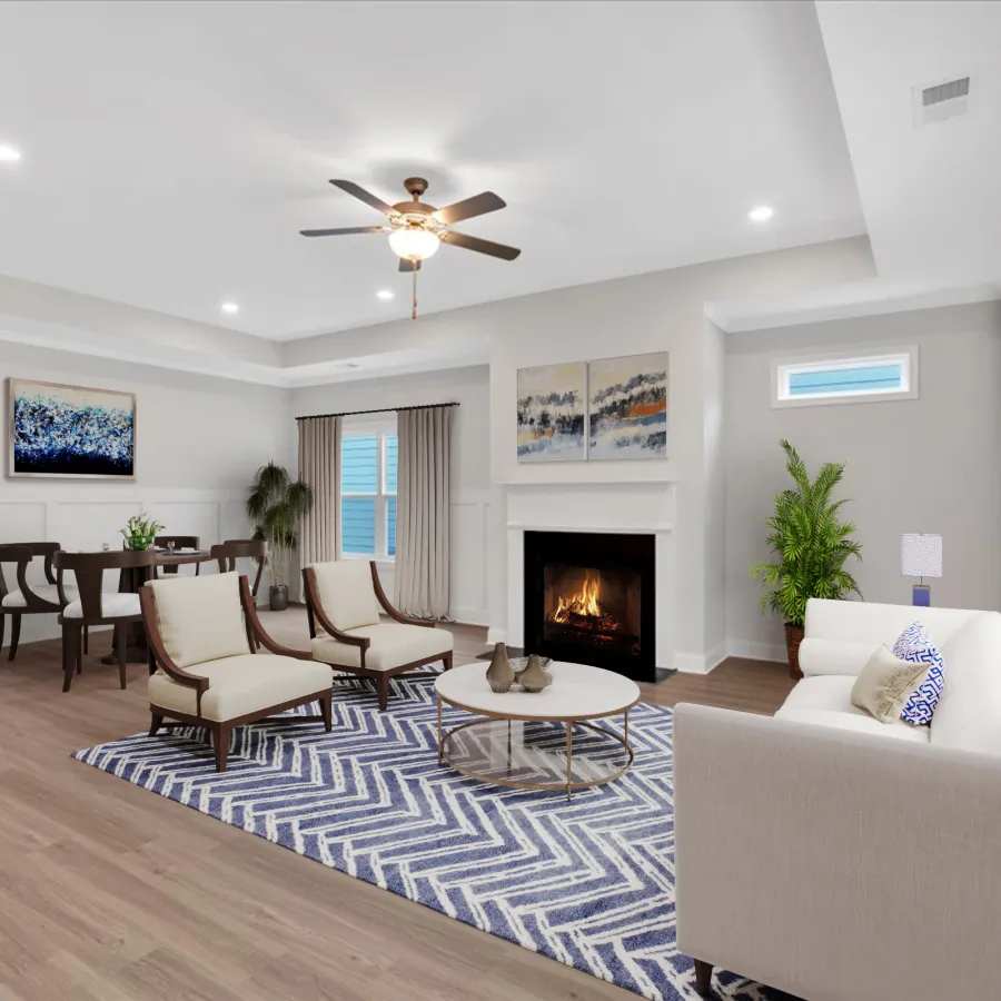 Spacious modern living room with fireplace, white sofa, two armchairs, blue patterned rug, and dining area in background.