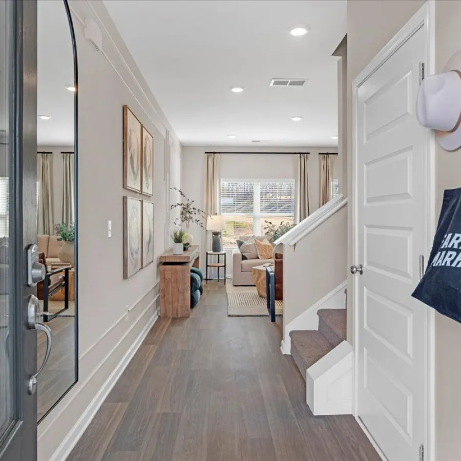 Bright and spacious entryway with a cozy living room and stylish decor elements.