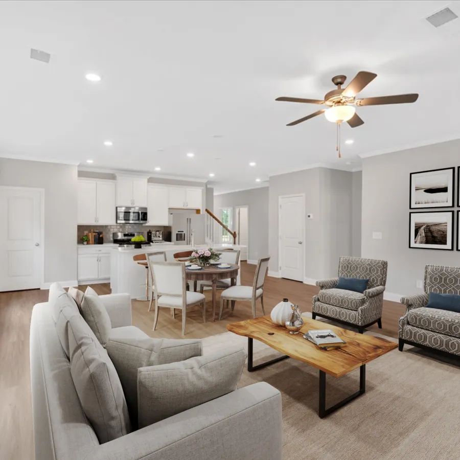 Bright open-concept living room and kitchen with modern furniture, wood floors, and ceiling fan light fixture