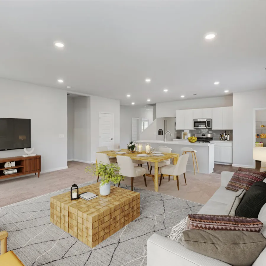Spacious open-plan living room and kitchen with modern furniture, neutral tones, and natural light.