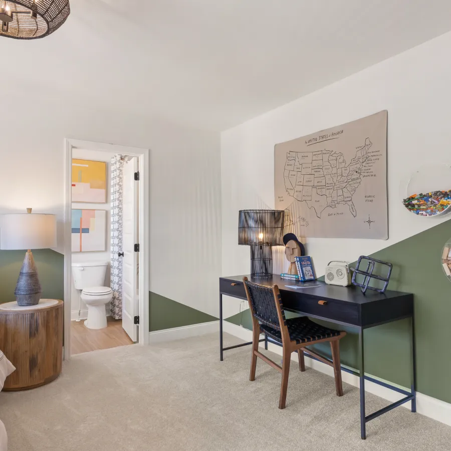 a room with a desk and a bed