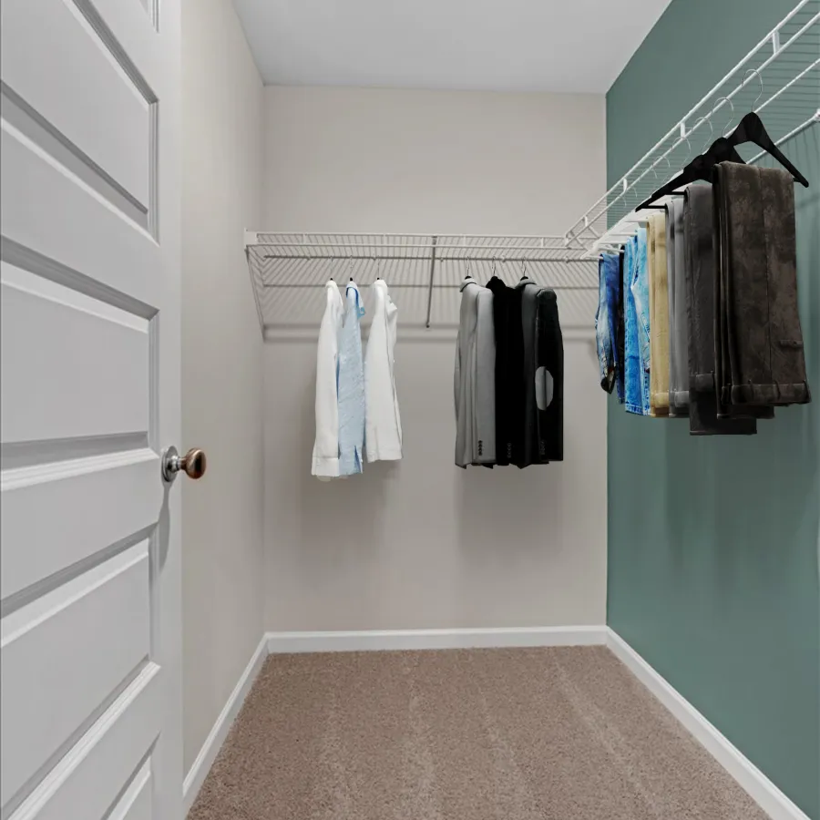 a room with a door and a rack of clothes