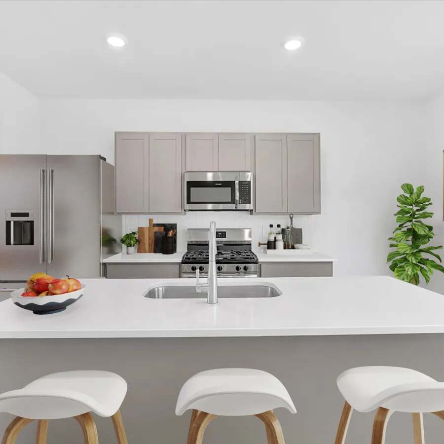 Modern kitchen with sleek cabinetry, stainless steel appliances, and minimalist decor featuring a central island.