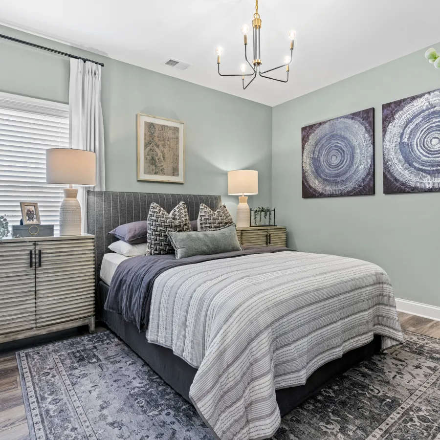 a bedroom with a bed and lamps