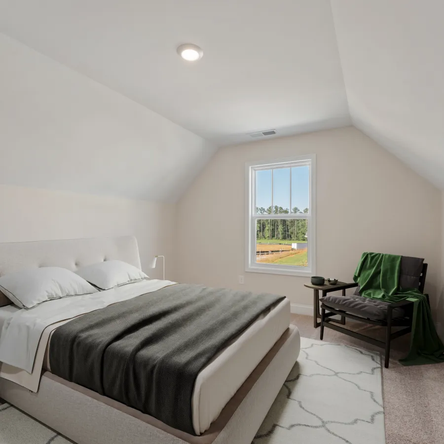 a bedroom with a bed and a chair