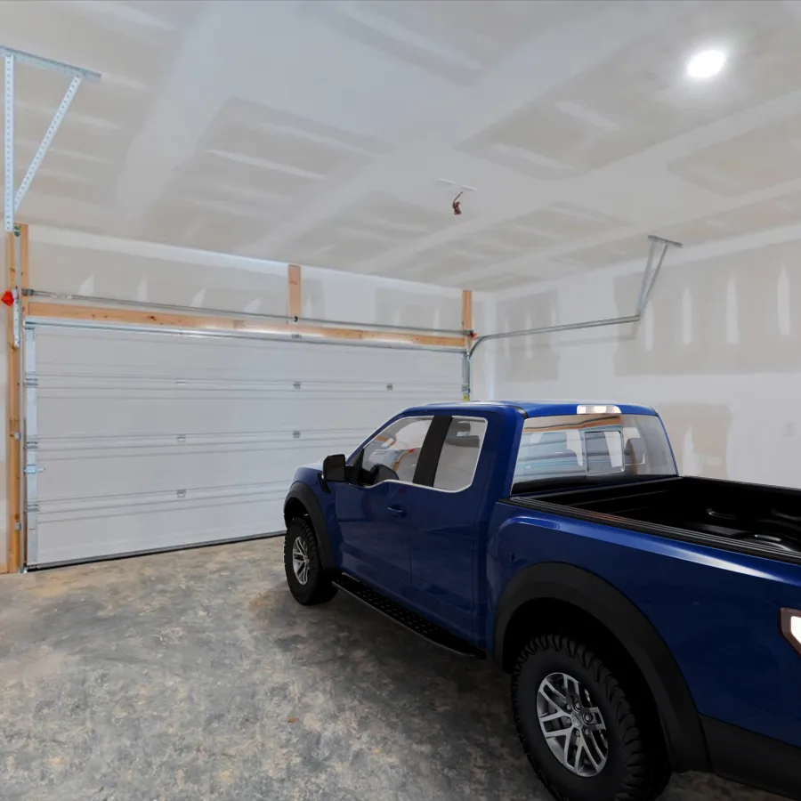 Blue pickup truck parked inside a spacious unfinished garage with white drywall and concrete floor.