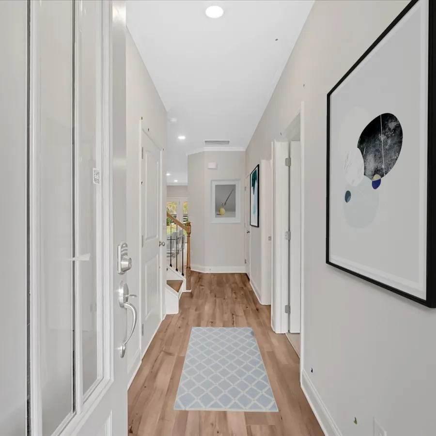 Contemporary corridor with hardwood flooring and modern artwork on the wall.