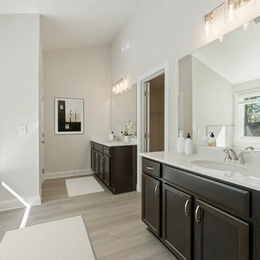 a bathroom with a tub sink and cabinets