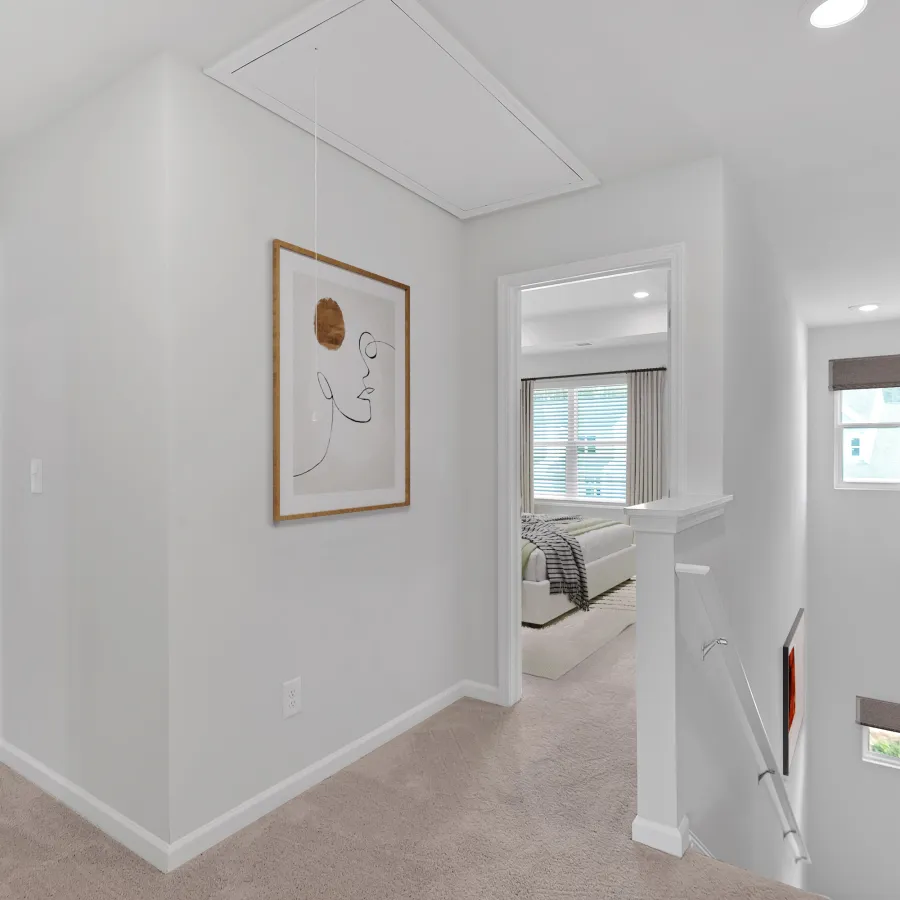 Bright hallway with modern decor, artwork, and natural light highlighting stylish elements and neutral colors.