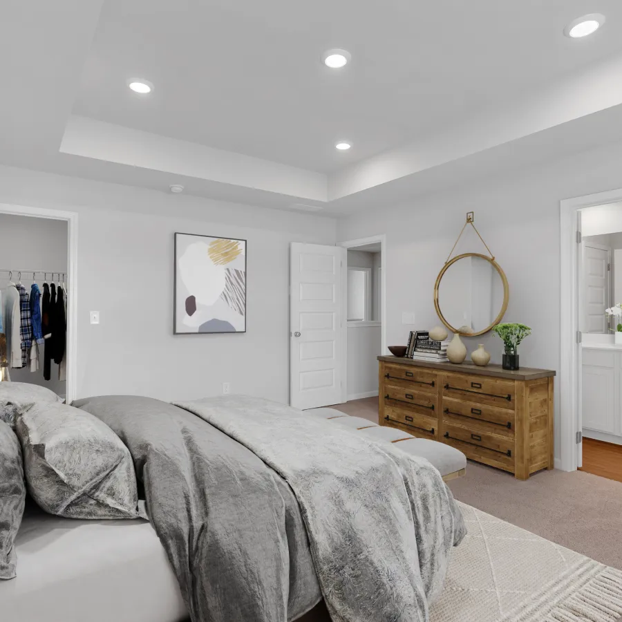 Modern bedroom with a comfortable bed, stylish decor, and ensuite bathroom access.