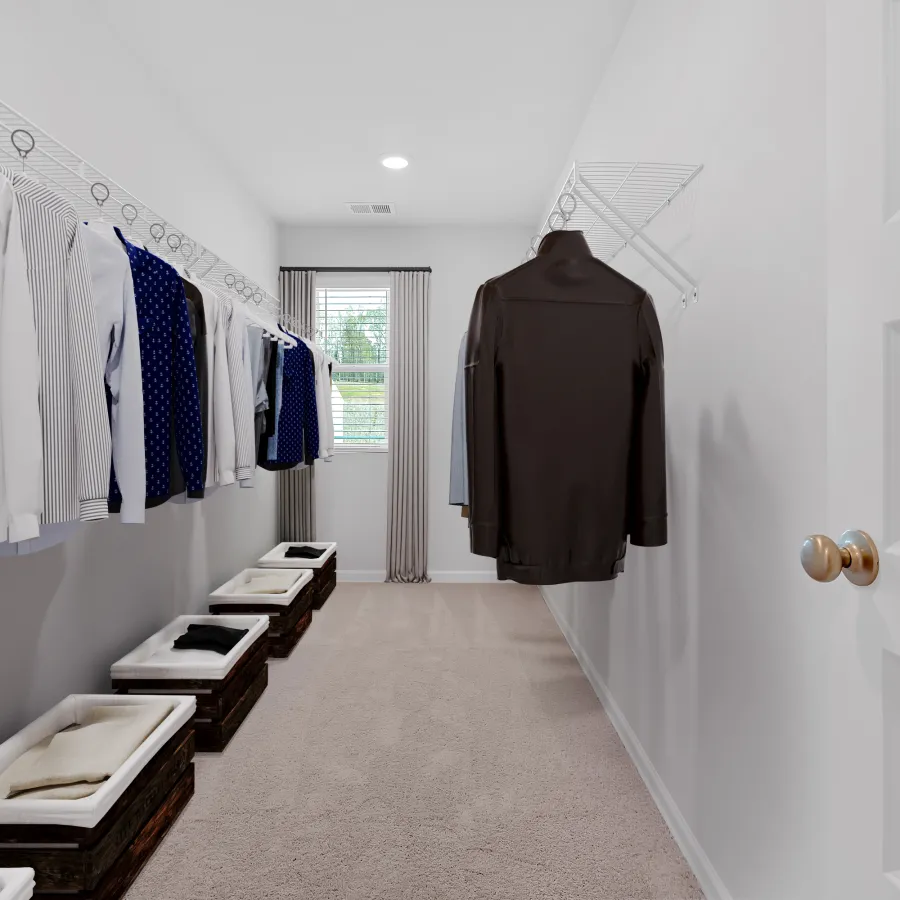 Organized walk-in closet with neatly hung shirts and storage baskets on a plush carpet.