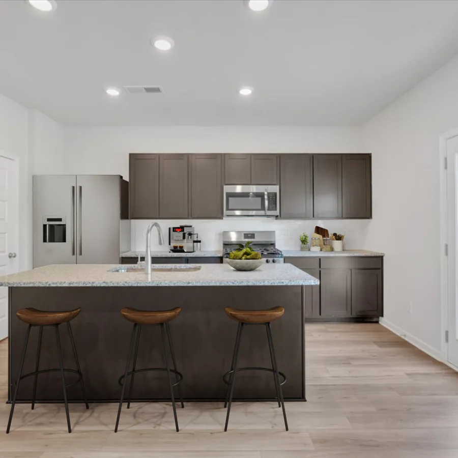 Modern kitchen with gray cabinets, granite island, stainless steel appliances, and wooden bar stools on light wood floor