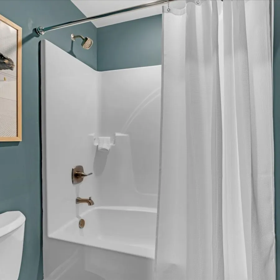 a bathroom with a tub and toilet