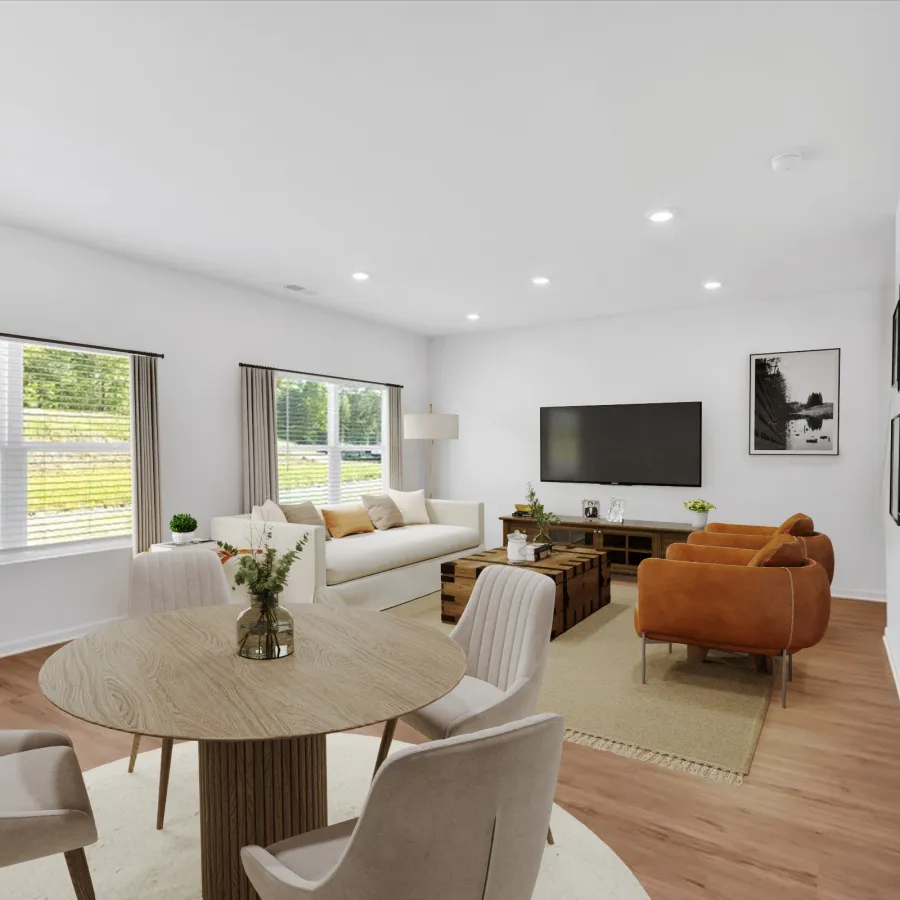 Bright and modern living room with a sofa, dining table, and entertainment center.