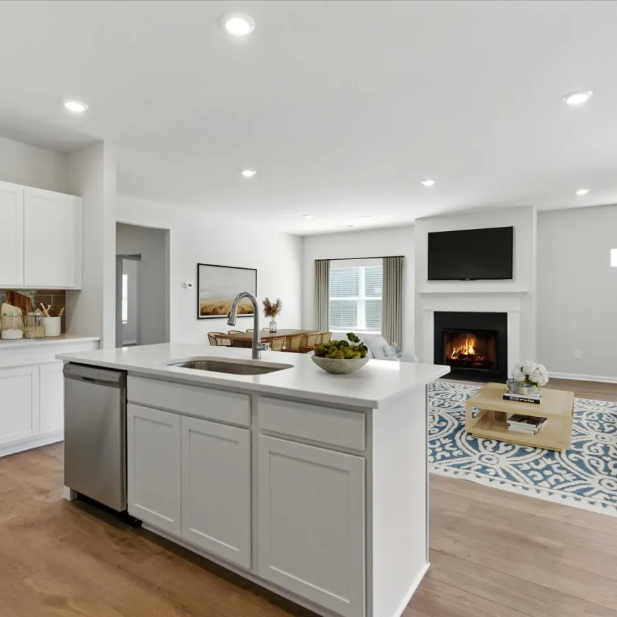 Modern open-concept kitchen and living room featuring white cabinetry, a central island, and a cozy fireplace.