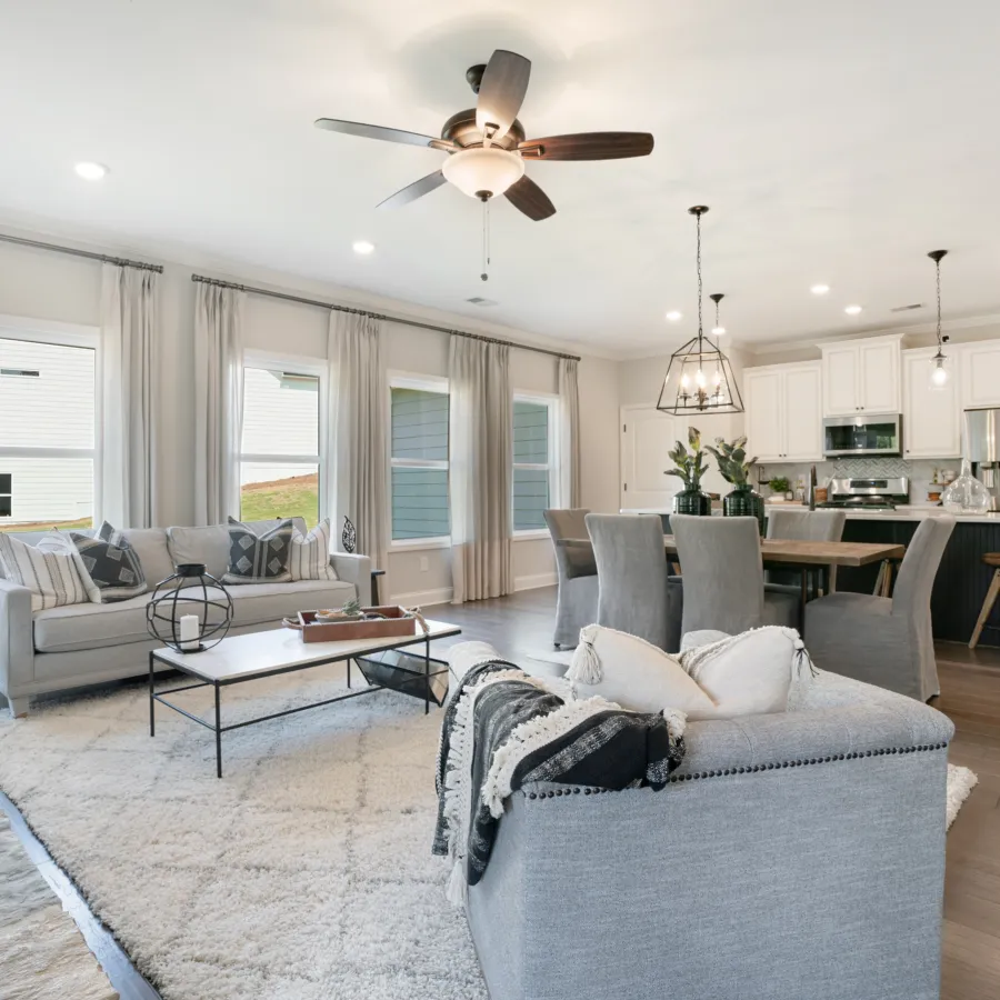 a living room filled with furniture and a large window