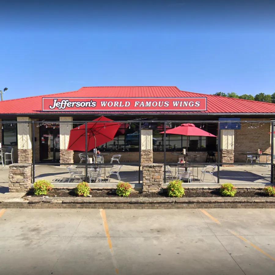Jefferson's World Famous Wings restaurant with red roof, outdoor seating, and red umbrellas on a sunny day.