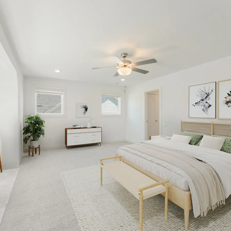 Bright modern bedroom with a king bed, beige bench, ceiling fan, green pillows, two framed artworks, and natural light.