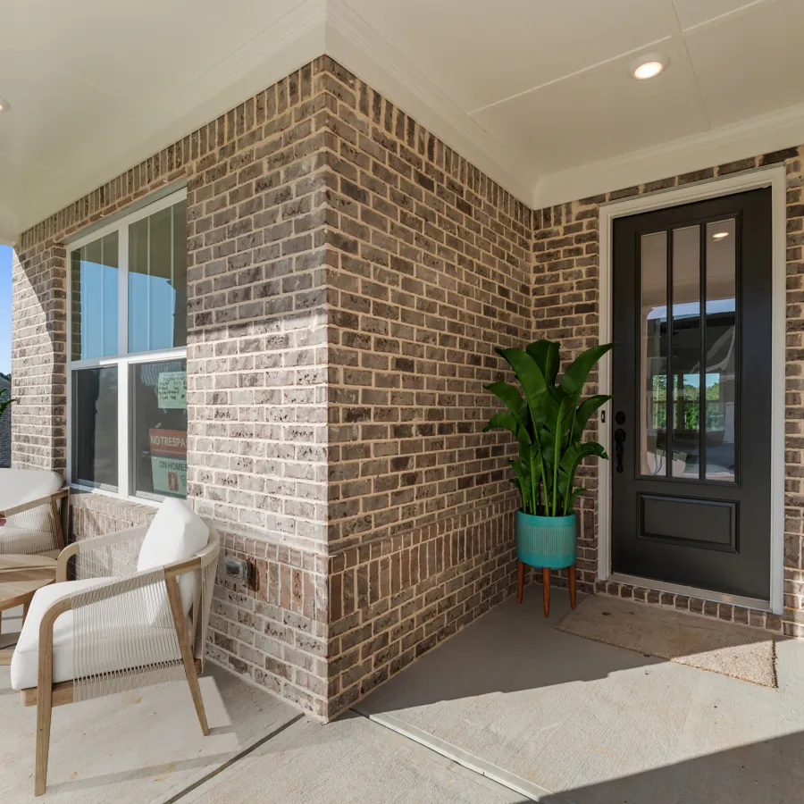 a brick house with a patio and a table and chairs