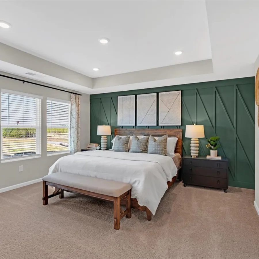 a bedroom with a bed and a bench