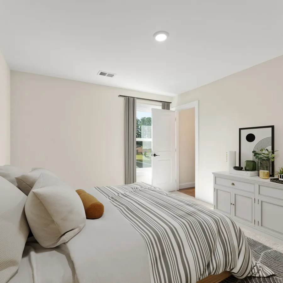 a bedroom with a bed and a couch