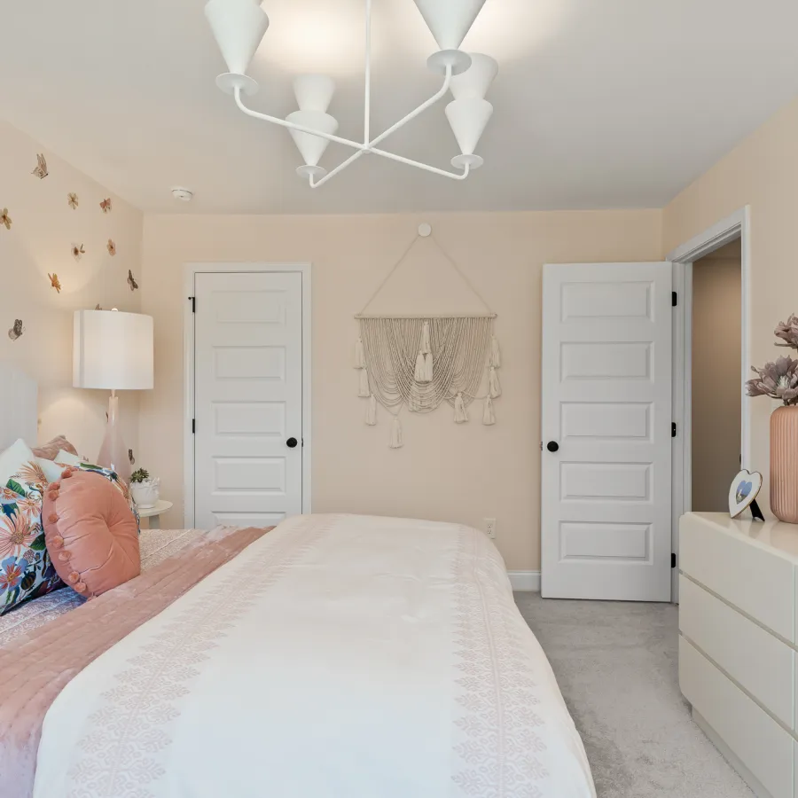 a bedroom with a bed and a mirror