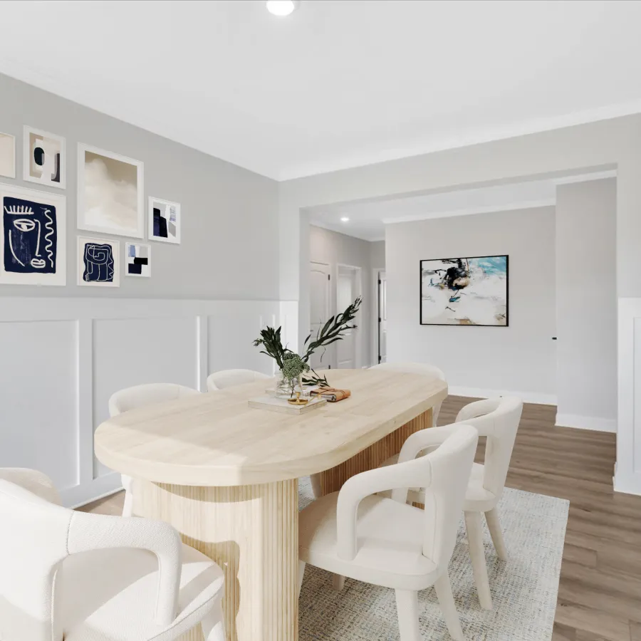 Modern dining room with oval wood table, white upholstered chairs, abstract wall art, and wood flooring.