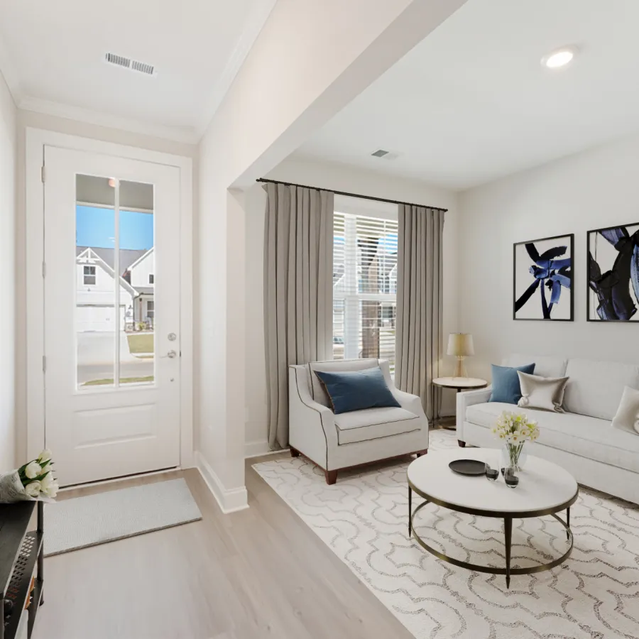 a living room with a white couch and a white table