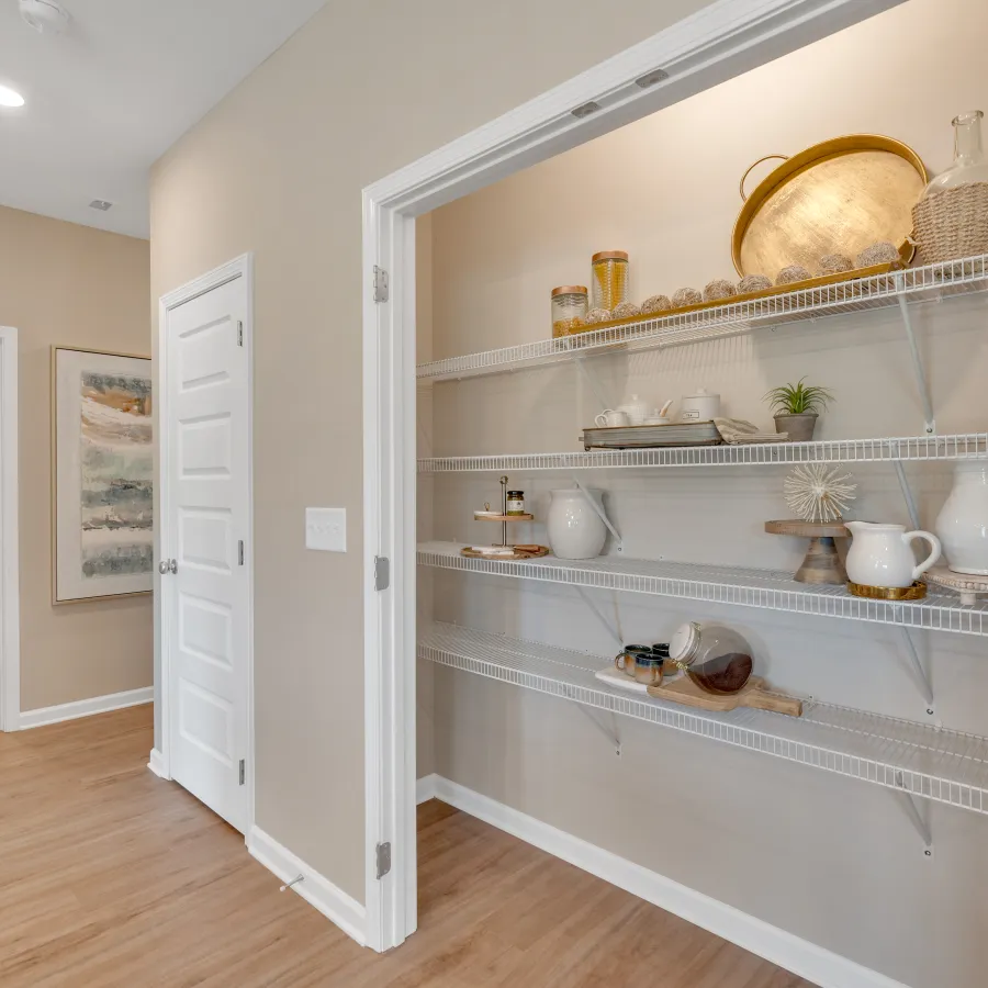 Modern hallway with open shelves displaying decorative kitchen items and neutral wall colors.