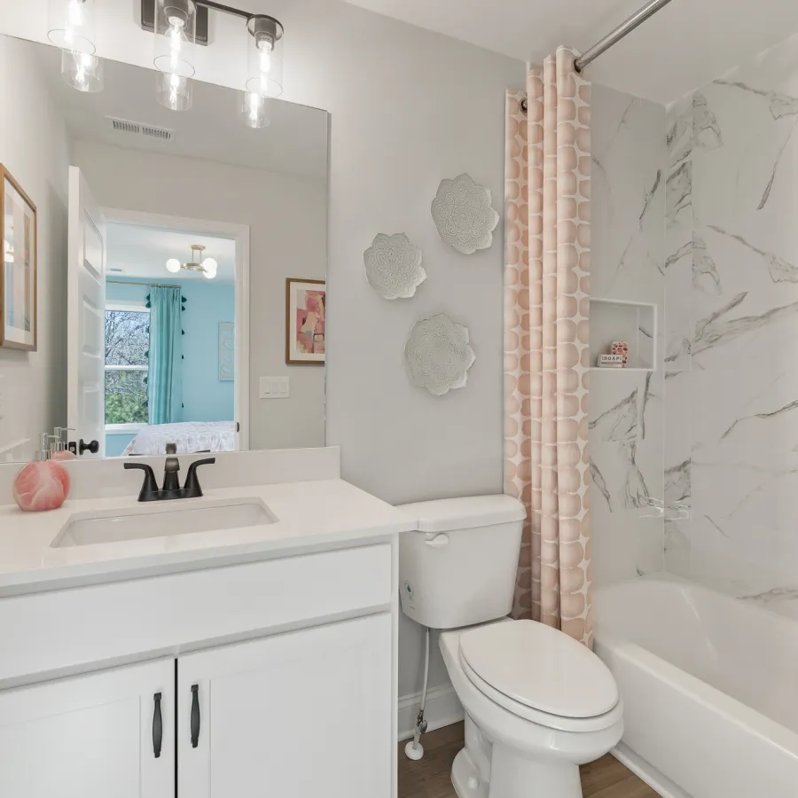 a bathroom with a tub toilet and sink