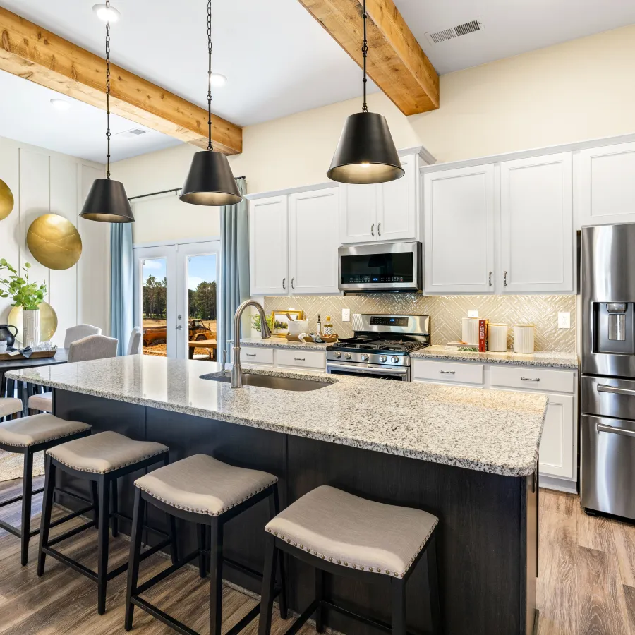a kitchen with a bar stool and a bar stool
