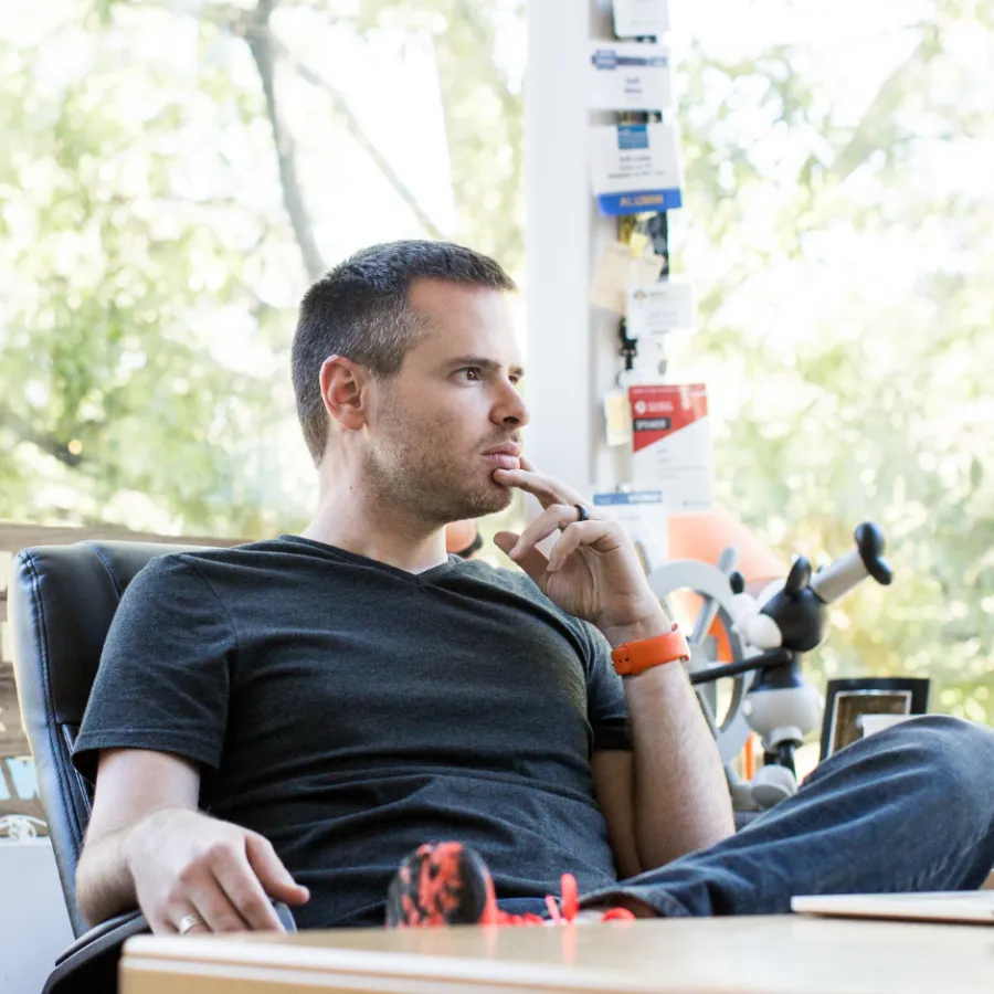 Jeff Jahn sitting at a table smoking a cigarette