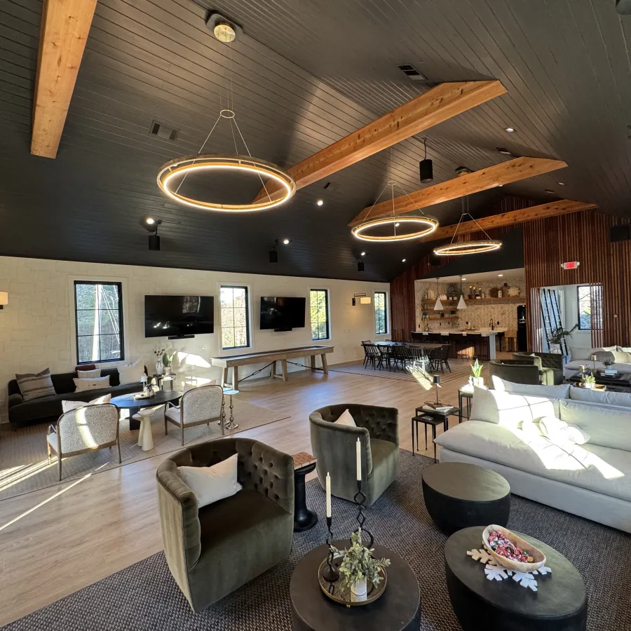 a large living room with a large chandelier and a large wood ceiling