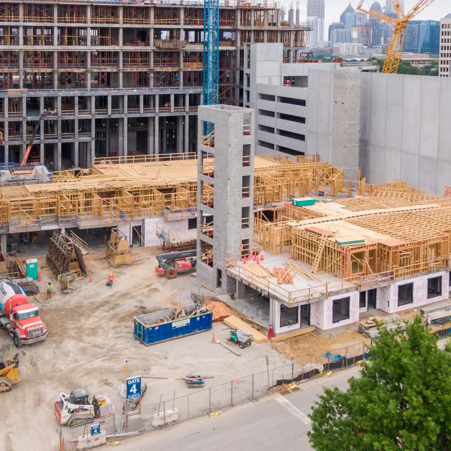 a construction site with cranes and buildings