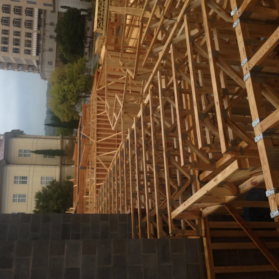 a wooden structure with a building in the background