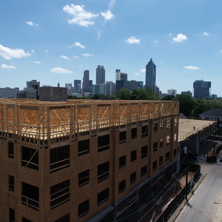 a large building with a city in the background