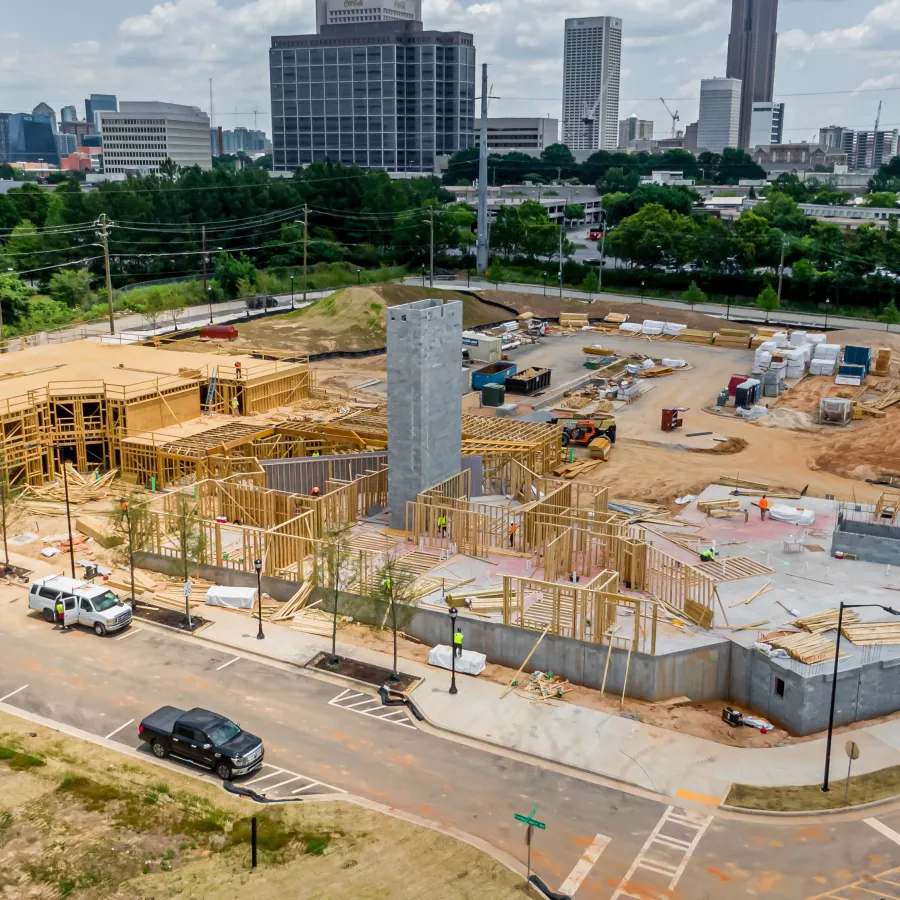 a construction site with cars and buildings