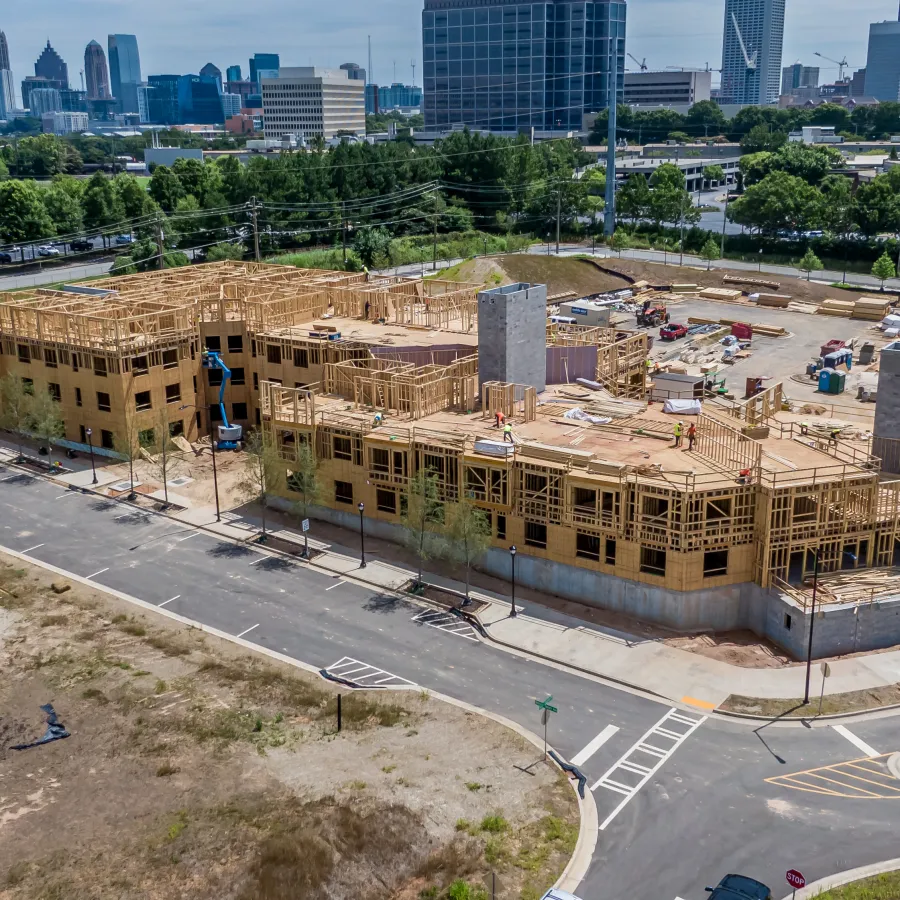 a large building with a lot of windows and a parking lot in front of it