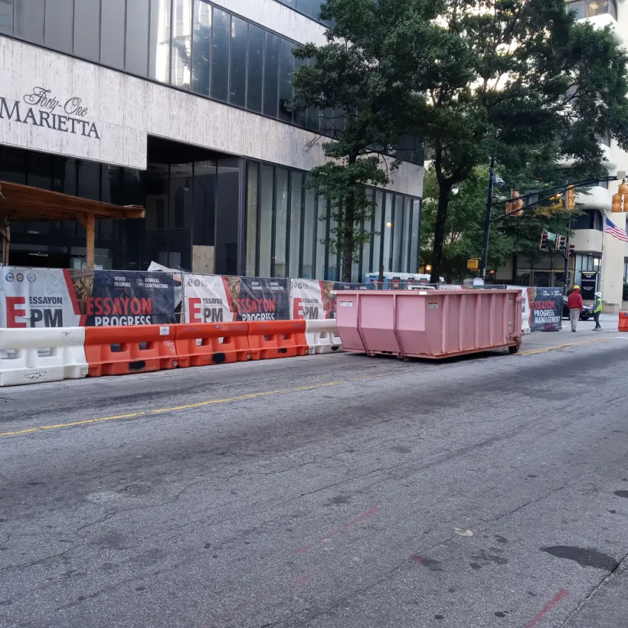 a road with construction signs and a truck on it