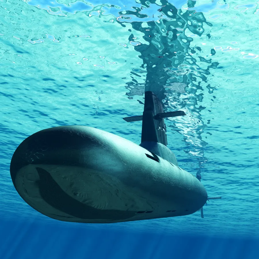 Submarine cruising underwater with light rays penetrating the clear blue ocean surface.