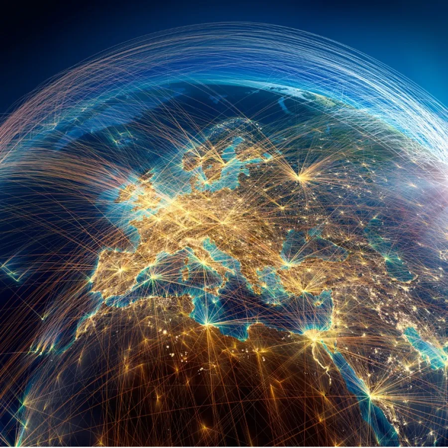 Digital globe showing interconnected lines and bright city lights across Europe and surrounding regions at night.