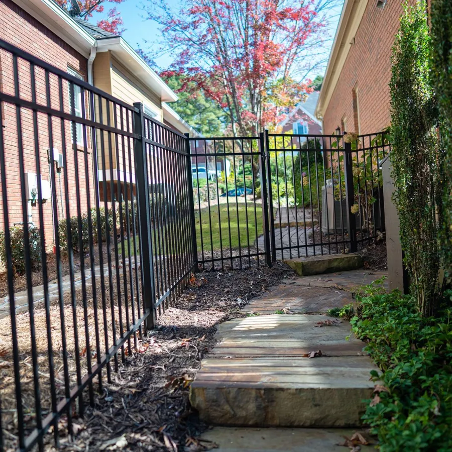 a gated yard with a bench