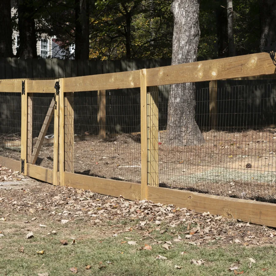 a wooden fence in a wooded area