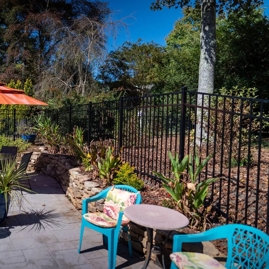 a patio with a table and chairs and umbrella