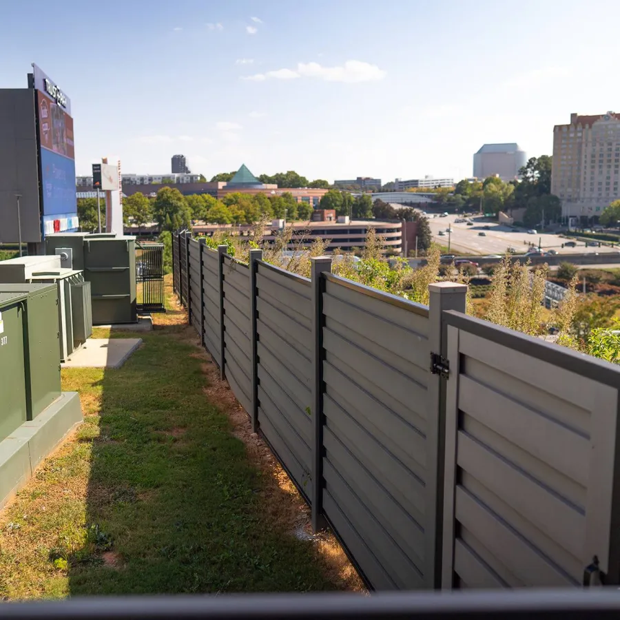 a fenced off area with buildings in the background