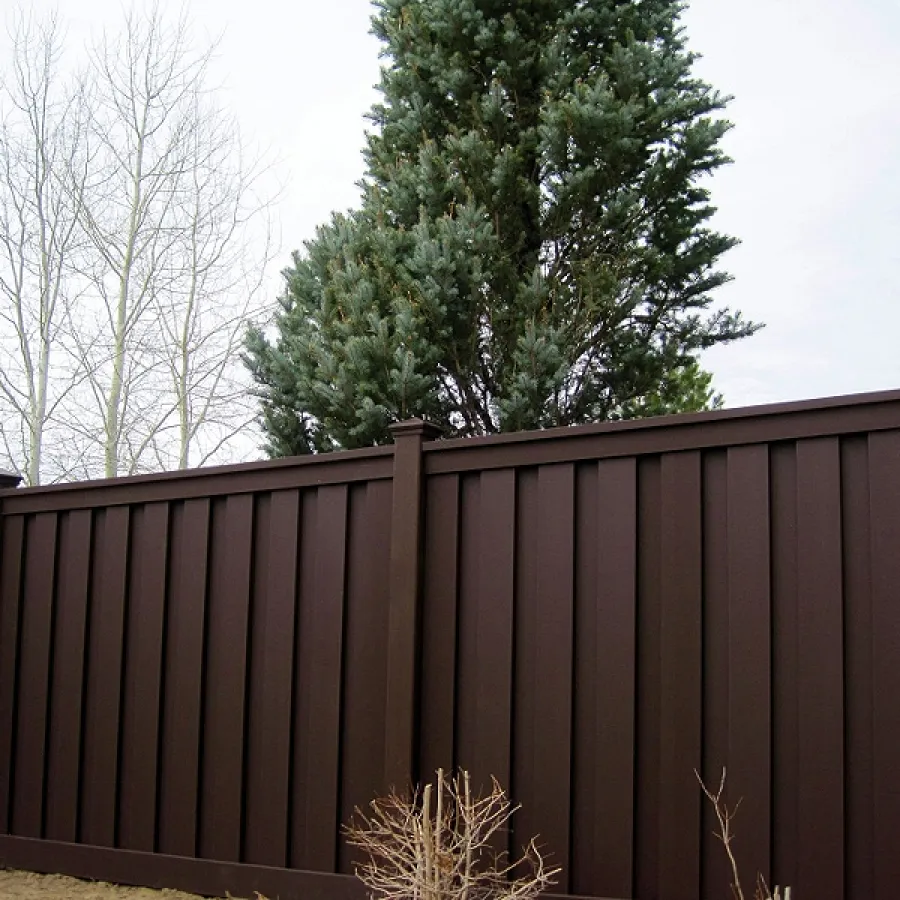 a wooden fence with trees in the background