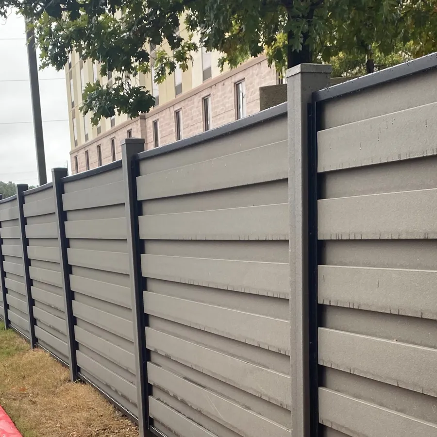 a fenced off area with a building in the background