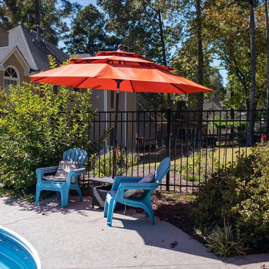 a patio with chairs and an umbrella