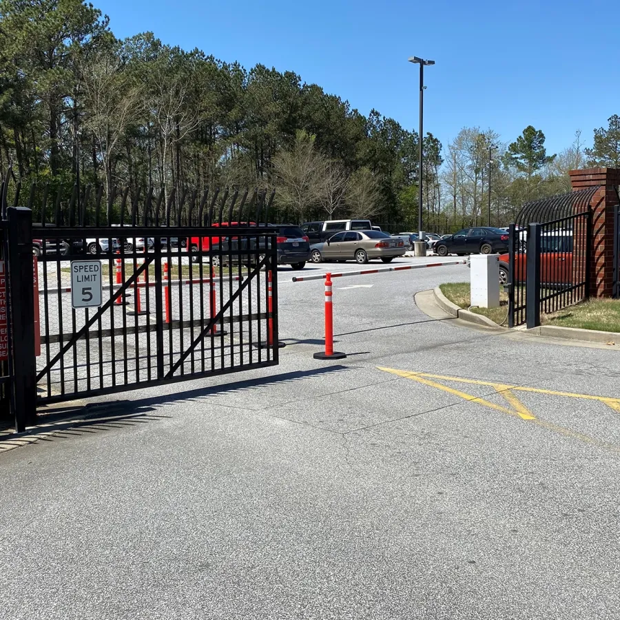 a road with a gate and cars on it