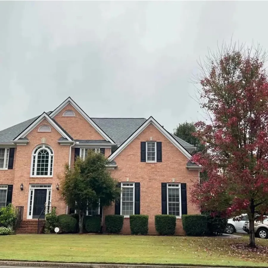 a brick building with a tree in front of it